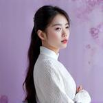 Portrait of Minji Kim, a female instructor playing a gayageum.