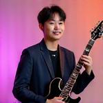 Portrait of Taehyun Park, a male instructor holding an electric guitar.